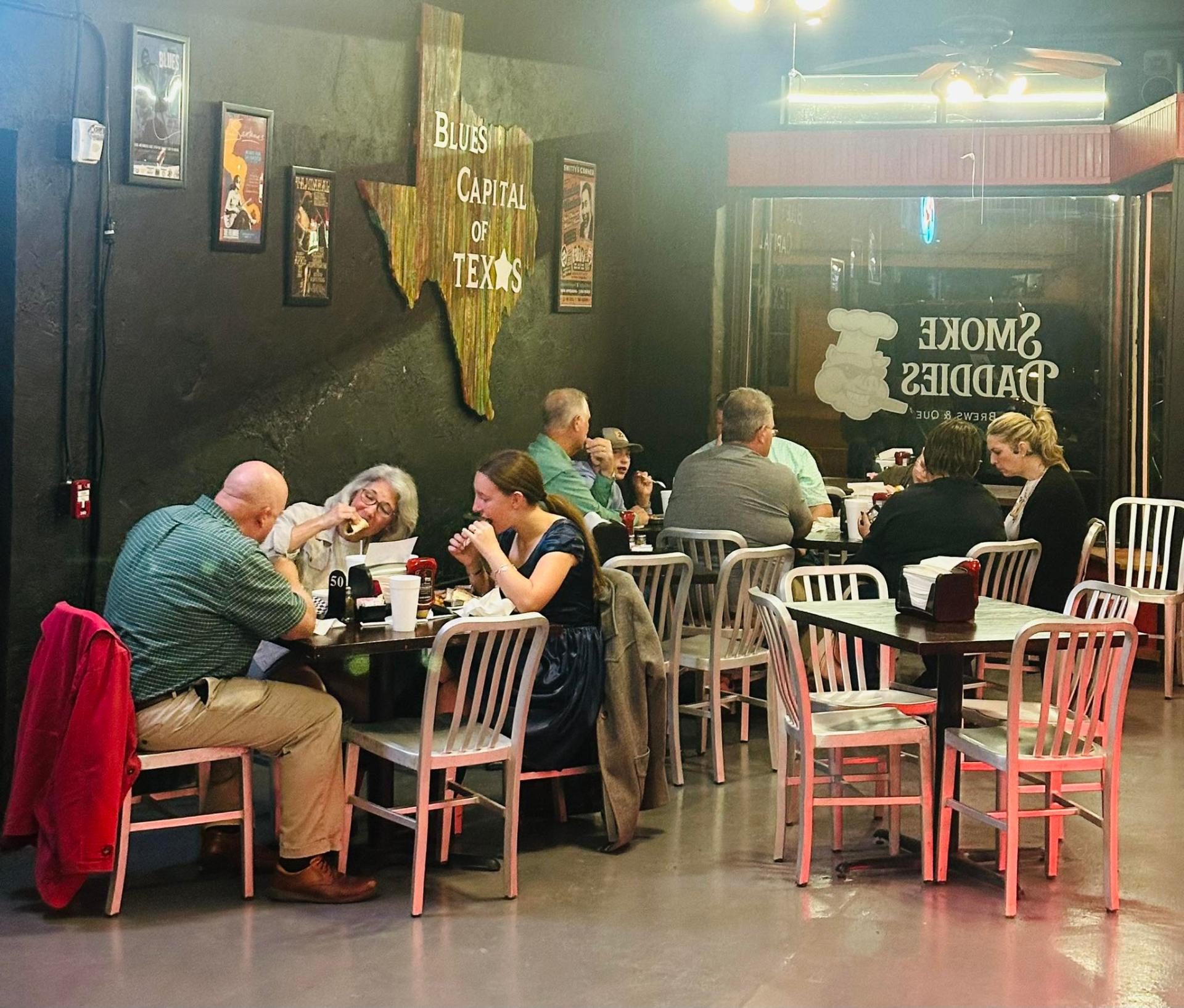 Smoke Daddies dining room with Blues Capital of Texas wall art