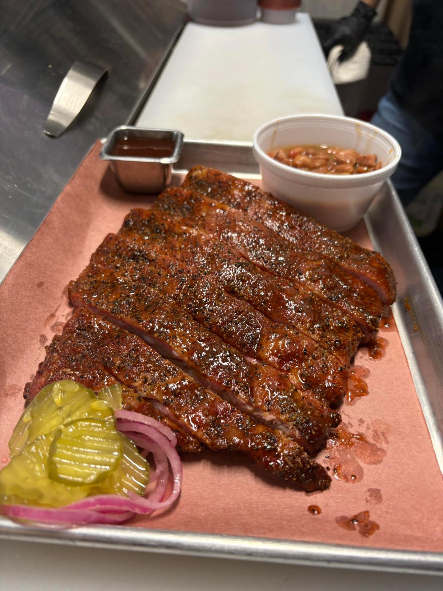 Smoked pork ribs with pickles, onions and pinto beans